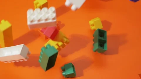 Blocks fall from the top to the orange background. Slow motion. 库存影片 143927732