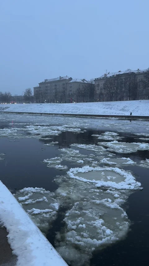 Blocks of ice floating on Neris river surface in Vilnius city center. Vertical Stock Footage 257351254