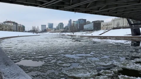 Blocks of ice floating on Neris river surface in Vilnius city center Stock Footage 257351279