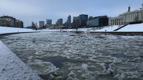 Blocks of ice floating on Neris river surface in Vilnius city center Stock Footage 257351321