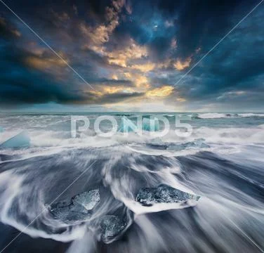 Blocks of ice washed by the waves on Jokulsarlon beach. Stock Photos