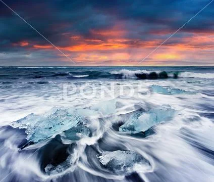 Blocks of ice washed by the waves on Jokulsarlon beach. Stock Photos