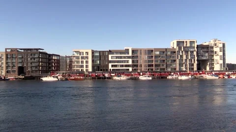 Blocks of modern exclusive condos behind cosy old red fishermen's cottages 스톡 동영상 47891826