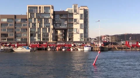 Blocks of modern flats and condos behind original cosy, red fisherman's cottages Video stock 48299885