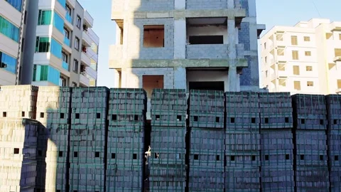 Blocks piled on pallets at construction site, camera shows large stack against Stock Footage 262896509