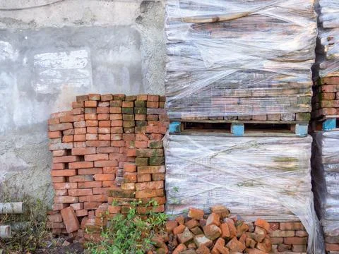 Blocks of red bricks in polyethylene. Brick pallets. Forget building materi.. Stock Photos