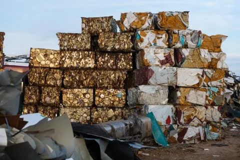 Blocks of rusty compacted cans and other metals in a scrap yard near Sierra de Stock Photos
