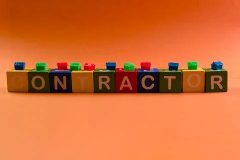 Blocks spell contractor on orange background Stock Photos