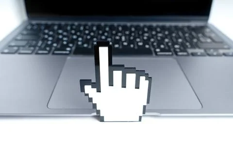 Blocky Hand Shaped Mouse Pointer Toy Model by a Laptop Stock Photos