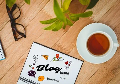 Blog doodle on notepad next to tea, glasses and plant Stock Photos