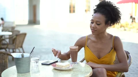 A blogger eats breakfast lunch in the city on the street. Stock Footage 154451514