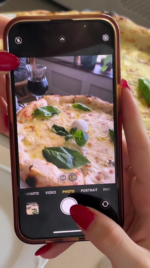 Blogger eats pizza Takes pizza on phone. process of filming on phone, creating Stock Footage 280205043