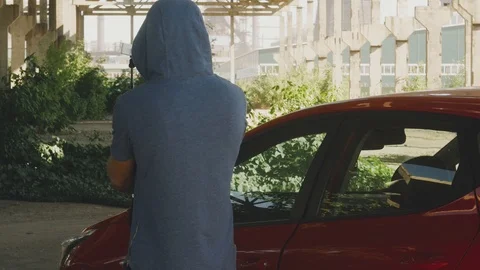 Blogger is filming on an action camera at the red car on the background of the Stock Footage 111865576