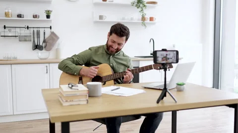 Blogger filming video tutorial about guitar playing Stock Footage 253323011