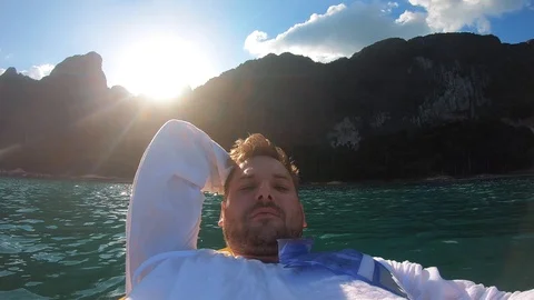 The blogger guy is lying on a kayak Stock Footage 123153049