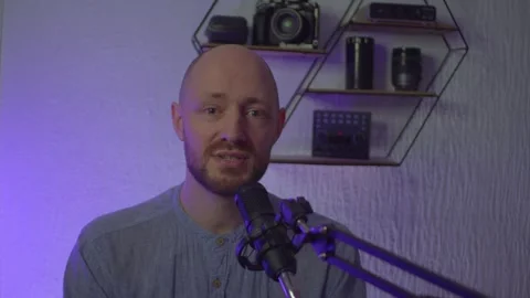 A blogger guy is recording in a studio Video stock 305230878