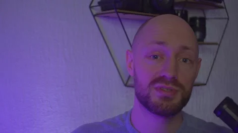 A blogger guy is recording in a studio Stock Footage 305230891