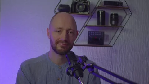 A blogger guy is recording in a studio Stock Footage 305238843