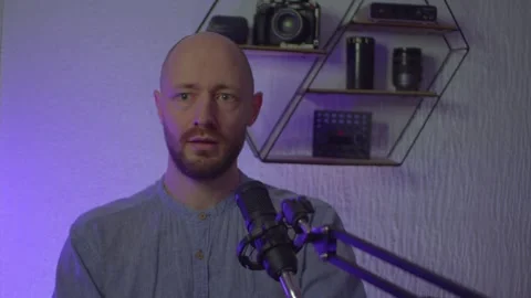 A blogger guy is recording in a studio Stock Footage 305239316