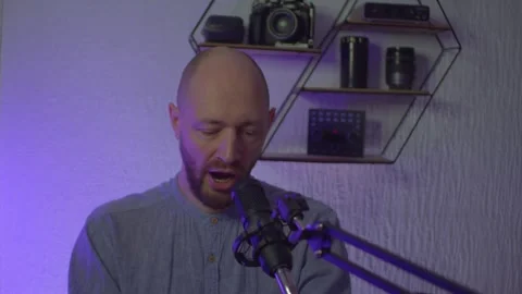 A blogger guy is recording in a studio Stock Footage 305239389