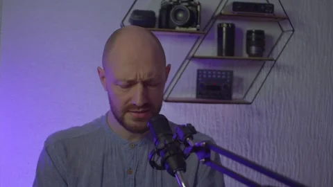 A blogger guy is recording in a studio Stock Footage 305239539