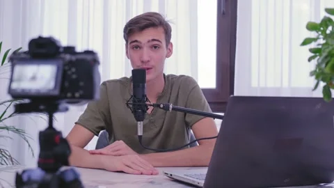 Blogger makes online streaming using smartphone . Man blogger videotapes his  Stock Footage 143281592