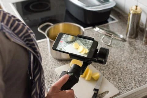 Blogger making smartphone video while cooking Stock Photos