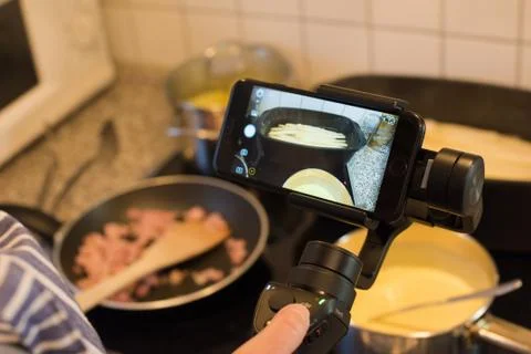 Blogger making smartphone video while cooking Stock Photos