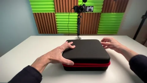 The blogger opens the case with the device in order to show it to the camera Stock Footage 239163900
