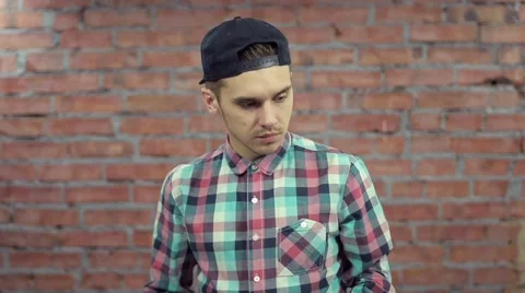 Blogger read script on papers, prepare for record. Brick wall on background Stock Footage 60403850