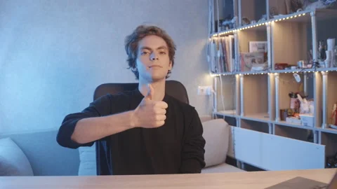 The blogger shows a thumbs up to the turned on camera. Camera view. Stock-Footage 204073946