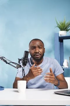 Blogger speaking in mic while streaming Photos