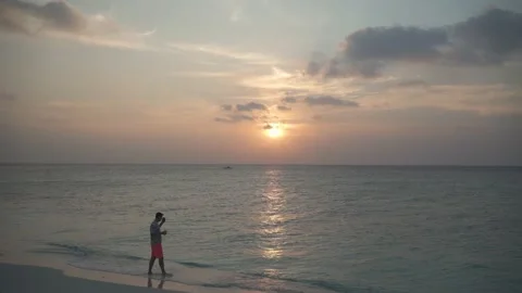 Blogger at sunset by the sea, something Stock Footage 146752105