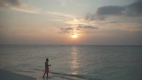Blogger at sunset by the sea, something writes Stock Footage 146752102