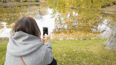Blogger Using Cell Phone To Take A Photo Of Fall Leaves for Social Media Stock Footage 117693080