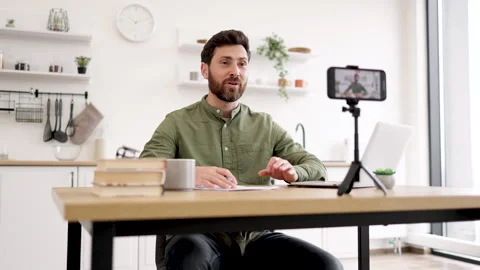 Blogger using mobile and tripod for creating video content Stock Footage 253314514