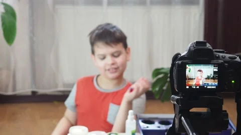 Blogging, technology and people concept boy or blogger camera recording video 库存影片 151036036