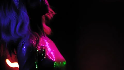 Blond African American girl dancing in slow motion in a club in neon lighting in Stock Footage