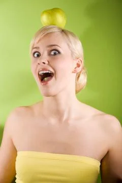 Blond with apple on head Stock Photos