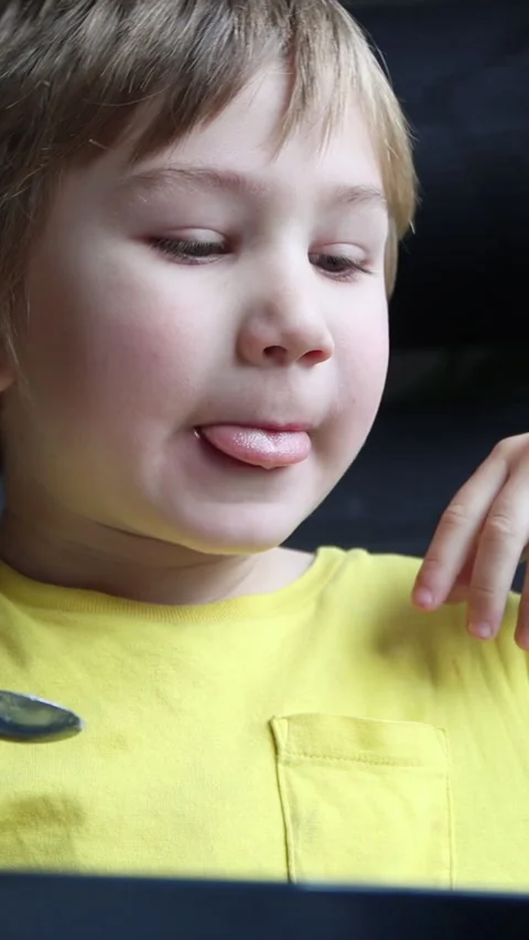 Blond boy eating and watching tablet montage Stock Footage 327012981