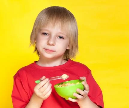Blond boy kid child eating corn flakes cereal 스톡 사진