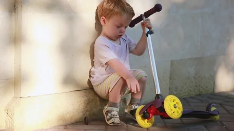 A blond boy with a scooter Stock Footage 157417377