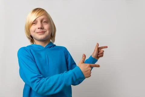 Blond boy smiling, indicating empty advertisement space on a white backgrou.. Stock Photos