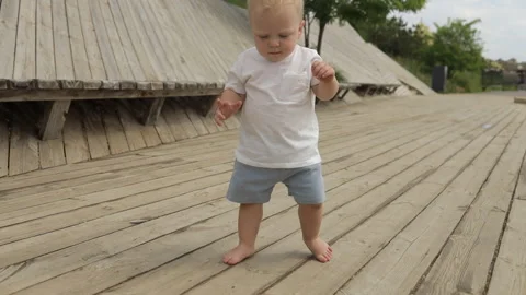 Blond boy taking first steps Stock Footage 197039180