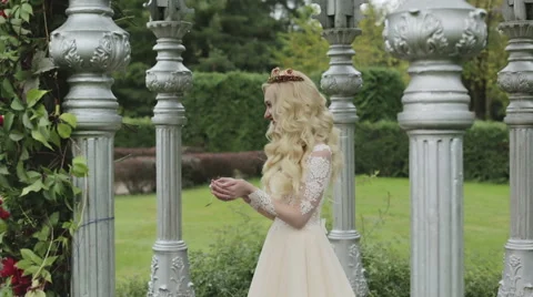 Blond bride in a cold autumn day in the park during a photo shoot. Stock Footage 68446682