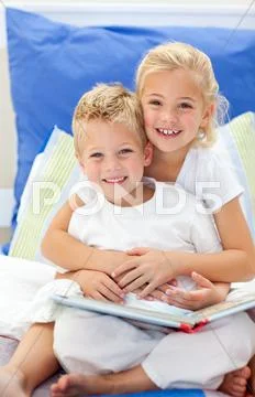 Blond brother and daughter reading books Stock Photos