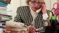 Blond business woman talking on phone, writing down information HD Footage