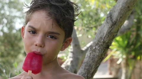 Blond child eats an ice lolly Stock Footage 134255214