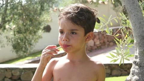 Blond child eats an ice lolly Stock Footage 134746340