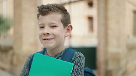 Blond child student holding books standi... | Stock Video | Pond5